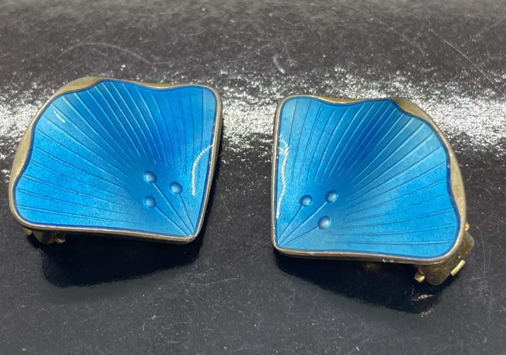 A pair of mid-century Norwegian fan-shaped clip-on earrings rendered in silver gilt with bright blue guilloche enamel, ribbed lines, and small dot accents. View II