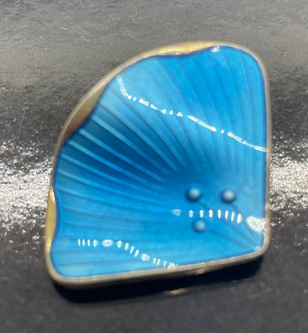 A pair of mid-century Norwegian fan-shaped clip-on earrings rendered in silver gilt with bright blue guilloche enamel, ribbed lines, and small dot accents. View VIII