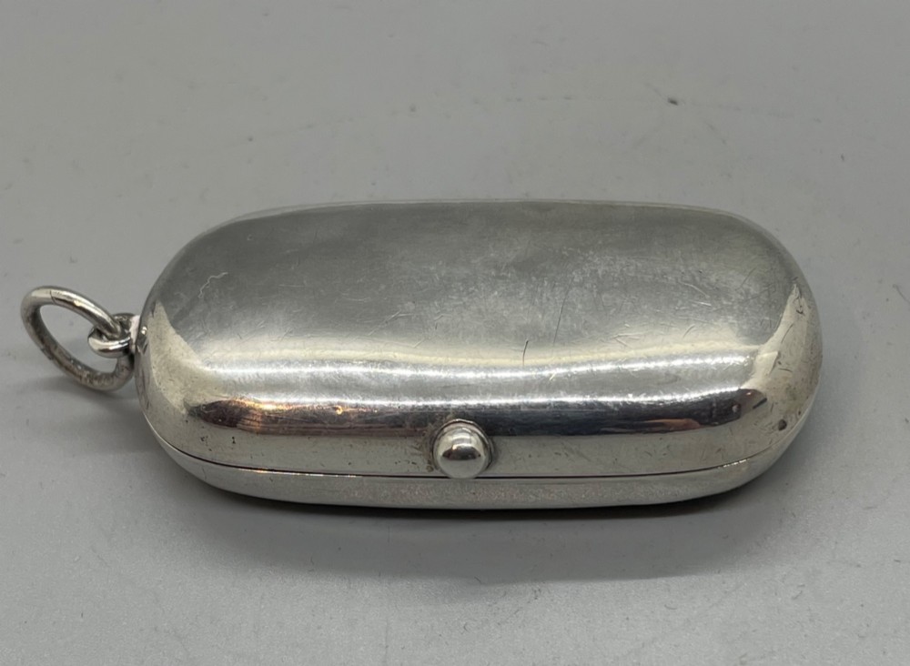 An oblong polished sterling silver double sovereign case featuring a top suspension loop and a push-button release catch. View II