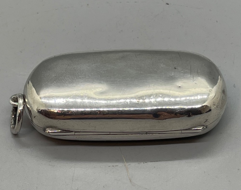 An oblong polished sterling silver double sovereign case featuring a top suspension loop and a push-button release catch. View VII