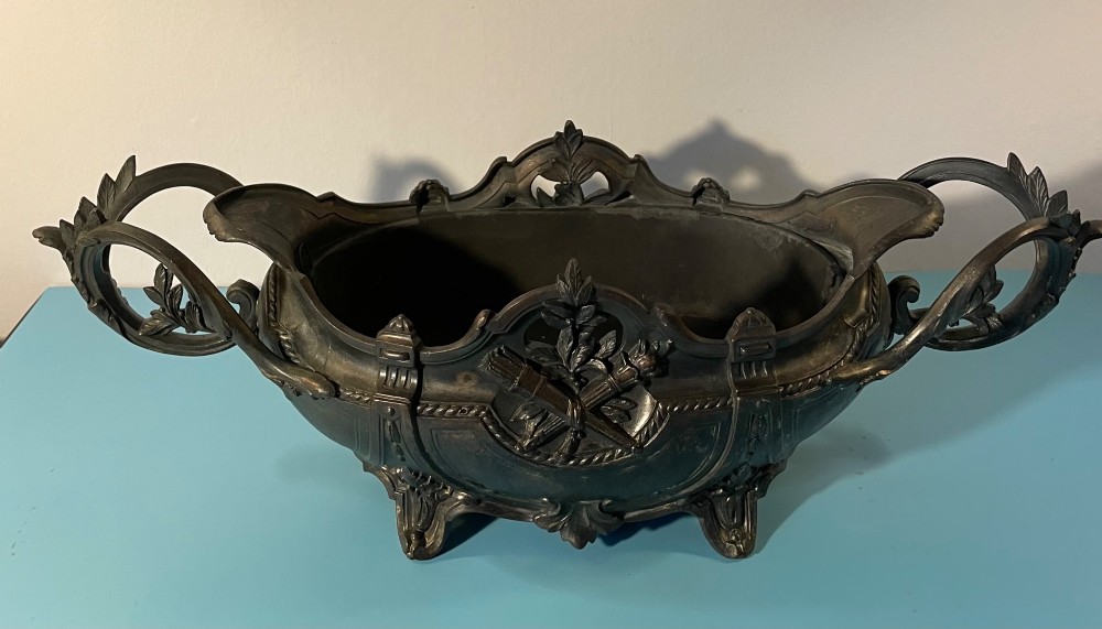 An ornate late 19th-century dark French cast metal jardiniere featuring foliage scrolls, twin handles, and central torch motifs. View II