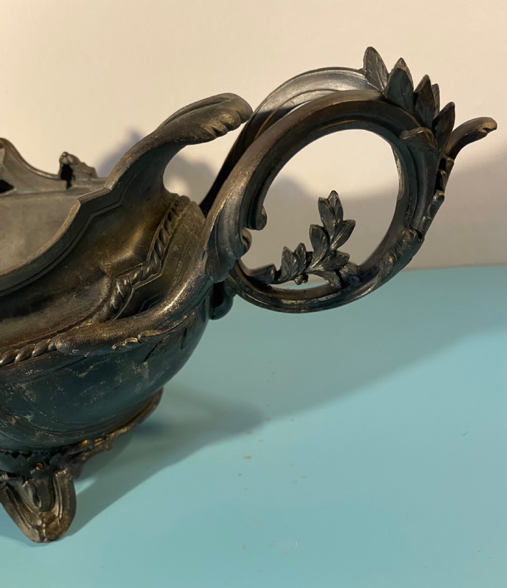 An ornate late 19th-century dark French cast metal jardiniere featuring foliage scrolls, twin handles, and central torch motifs. View VI