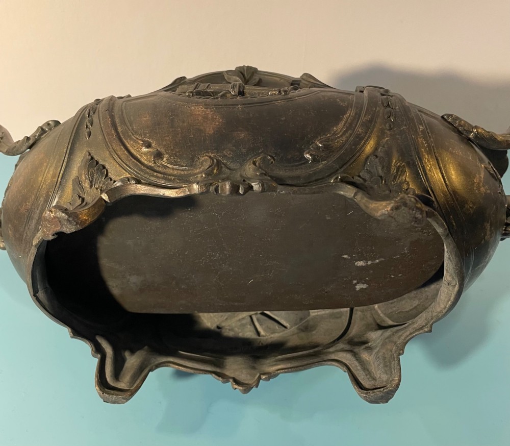 An ornate late 19th-century dark French cast metal jardiniere featuring foliage scrolls, twin handles, and central torch motifs. View VIII