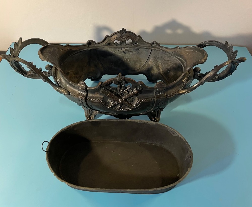 An ornate late 19th-century dark French cast metal jardiniere featuring foliage scrolls, twin handles, and central torch motifs. View IX