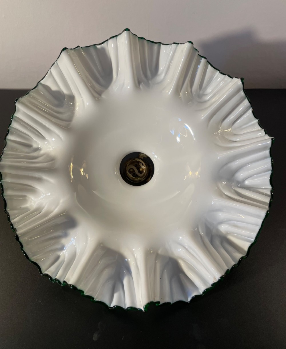 A white opaline glass lampshade with a fluted frilled edge trimmed in green glass, mounted with a brass top fixture. View VI