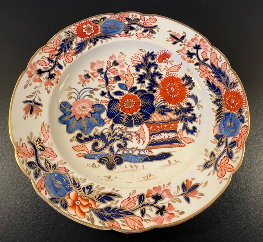 Three 19th-century Staffordshire plates featuring Imari floral designs in cobalt blue, iron red, pink, and gilt. View V