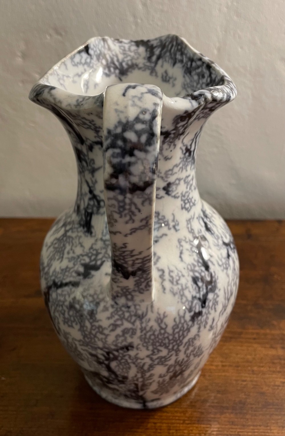 An early nineteenth-century Staffordshire flow blue ceramic wash set comprising a flared jug and matching wide wash basin with a mottled blue pattern. View VII