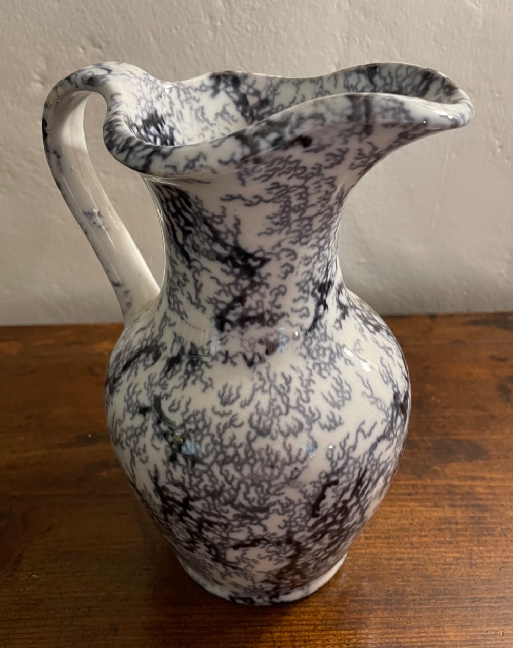 An early nineteenth-century Staffordshire flow blue ceramic wash set comprising a flared jug and matching wide wash basin with a mottled blue pattern. View VIII