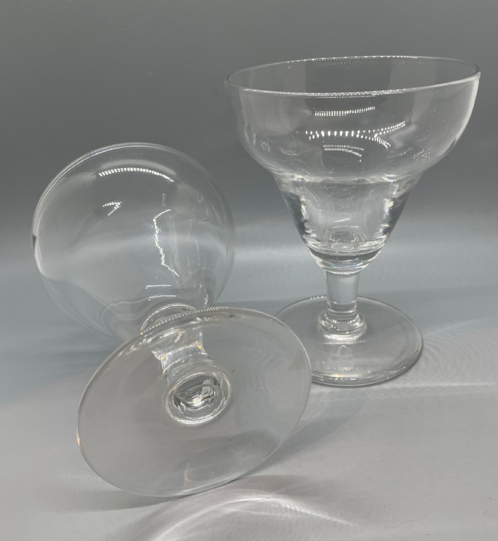 A matched pair of clear Georgian glass rummers featuring ogee-shaped bowls, short stems, and circular flat feet. View III