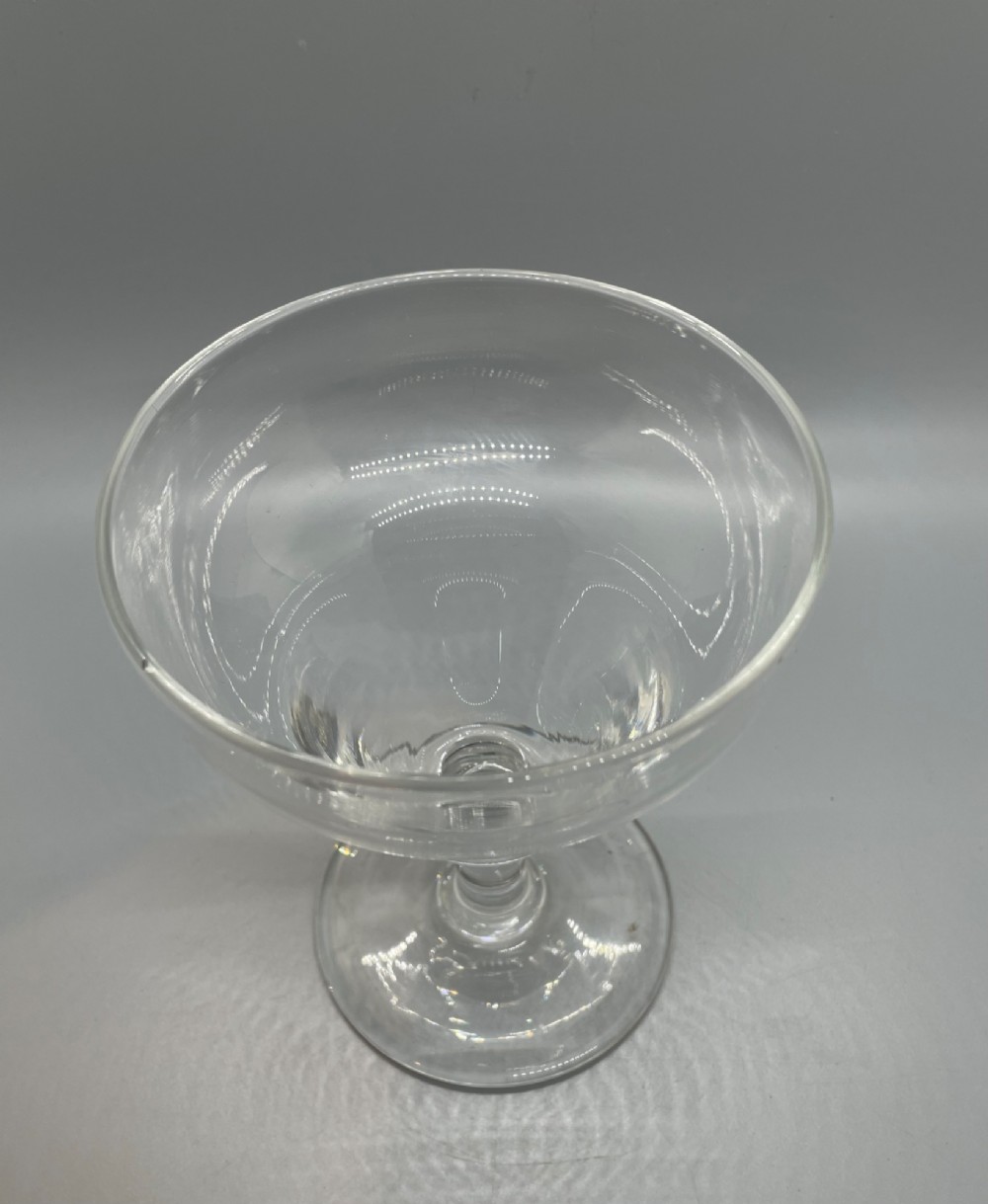 A matched pair of clear Georgian glass rummers featuring ogee-shaped bowls, short stems, and circular flat feet. View VIII