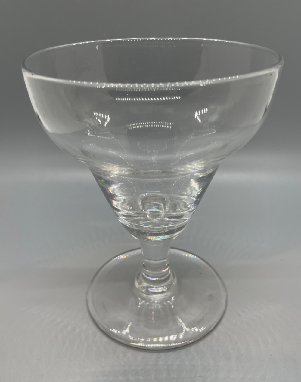 A matched pair of clear Georgian glass rummers featuring ogee-shaped bowls, short stems, and circular flat feet. View IX