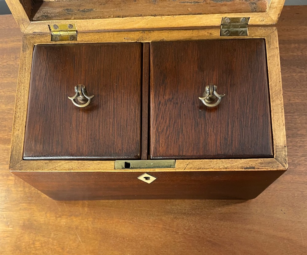 A rectangular Georgian dark mahogany tea caddy featuring delicate boxwood edge stringing and a diamond-shaped bone escutcheon on the front panel. View VI