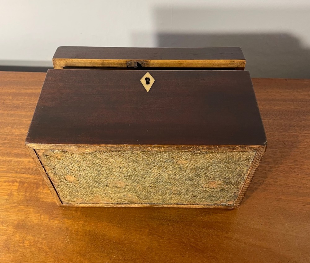 A rectangular Georgian dark mahogany tea caddy featuring delicate boxwood edge stringing and a diamond-shaped bone escutcheon on the front panel. View VIII