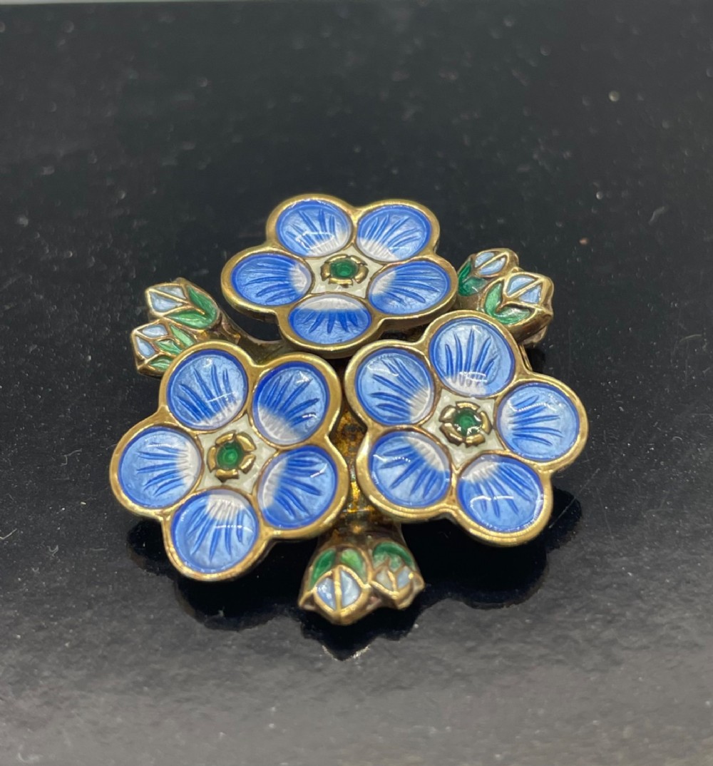 A David Andersen silver gilt brooch featuring three blue and white enamelled forget-me-not flowers with green centres and leaves. View II