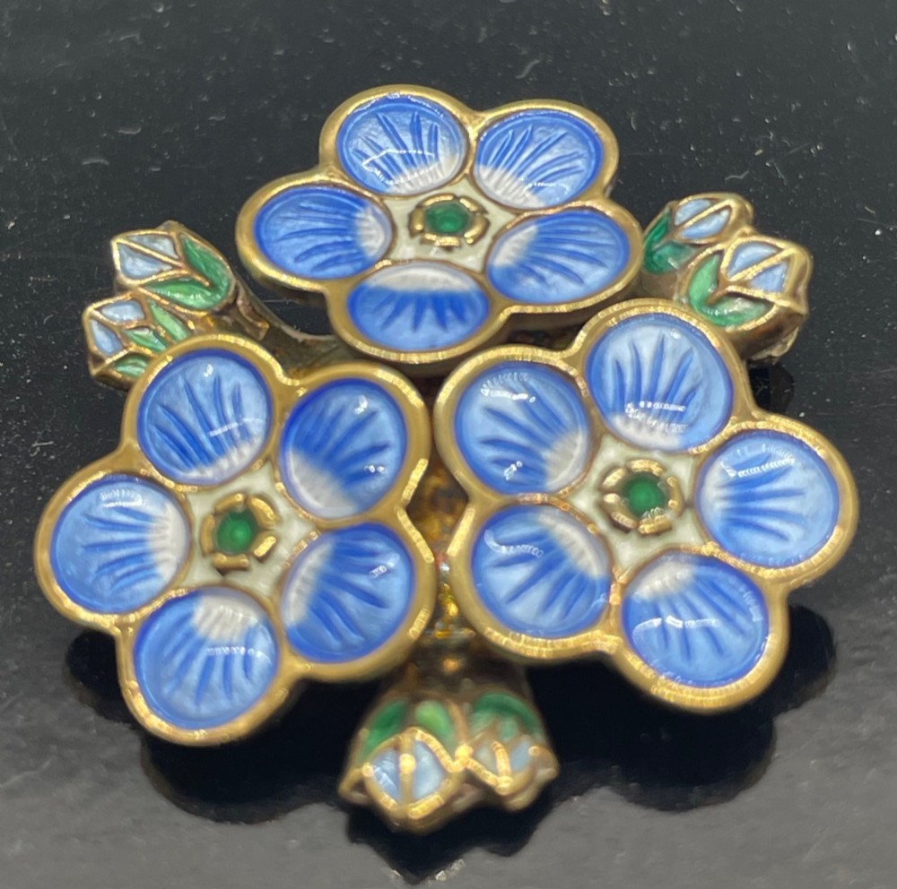 A David Andersen silver gilt brooch featuring three blue and white enamelled forget-me-not flowers with green centres and leaves. View III