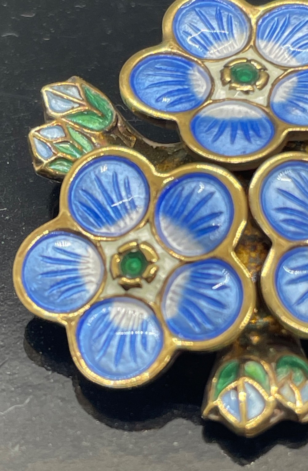 A David Andersen silver gilt brooch featuring three blue and white enamelled forget-me-not flowers with green centres and leaves. View IV