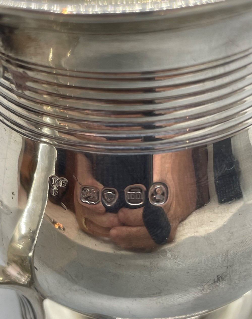 A George IV sterling silver baluster mug featuring a reeded collar, decorative acanthus leaf handle, and a stepped circular pedestal base. View VII