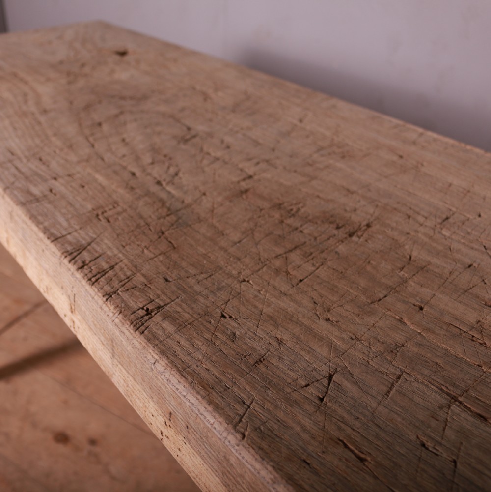 A long, narrow rustic French trestle table constructed from scrubbed sycamore and elm with four splayed legs. View IV