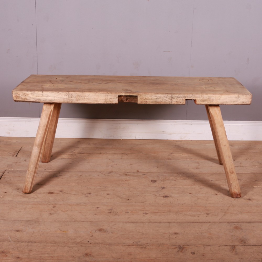 A rectangular wooden trestle table crafted from pale scrubbed timber with four angled splayed legs. View V