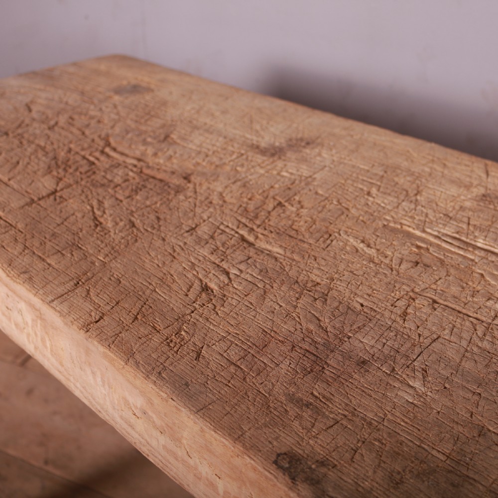 A rustic scrubbed sycamore and elm trestle table with a thick rectangular top and four splayed wooden legs. View III