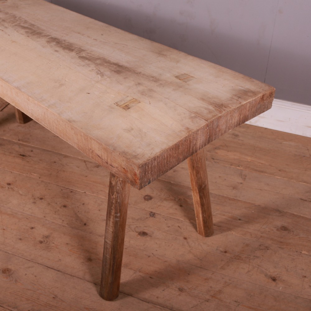 A rustic French trestle table crafted from scrubbed sycamore and elm featuring a thick rectangular top supported by splayed timber legs. View III