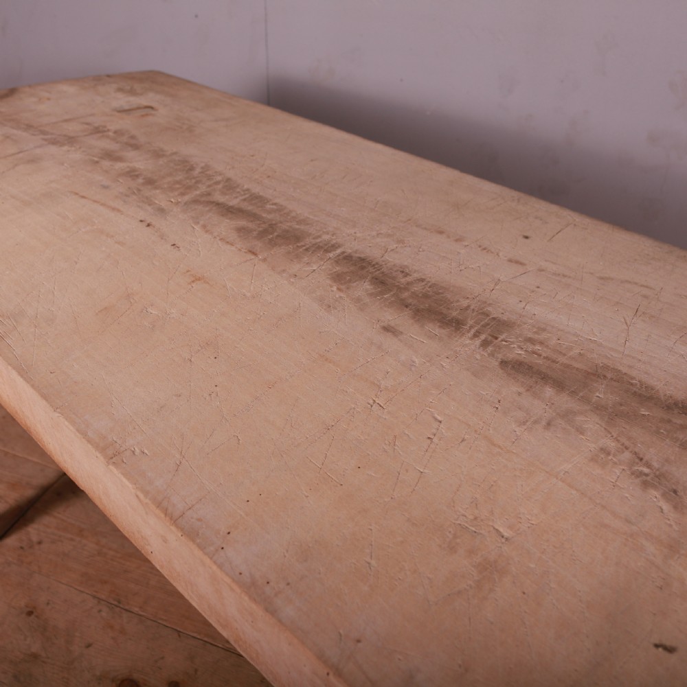 A rustic French trestle table crafted from scrubbed sycamore and elm featuring a thick rectangular top supported by splayed timber legs. View V