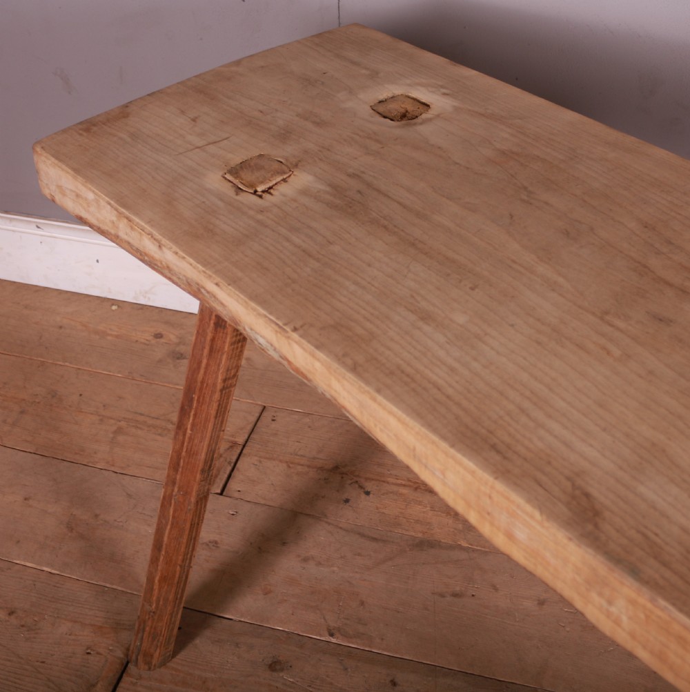A rustic rectangular timber trestle table crafted from pale sycamore and elm with splayed wooden legs and exposed joinery. View IV