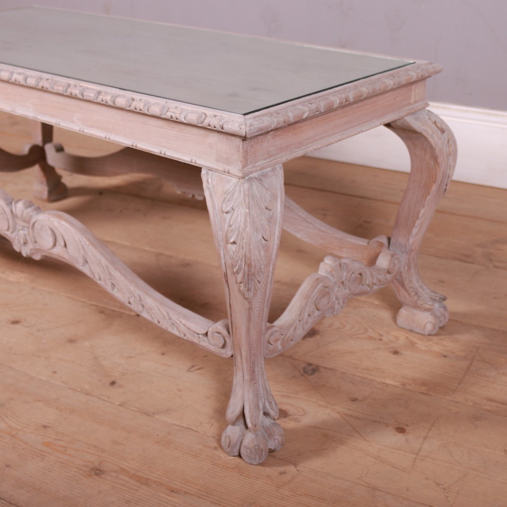 A low rectangular Dutch bleached pine coffee table featuring acanthus leaf carvings, ornate scrolled stretchers, claw feet, and an inset glass top. View II