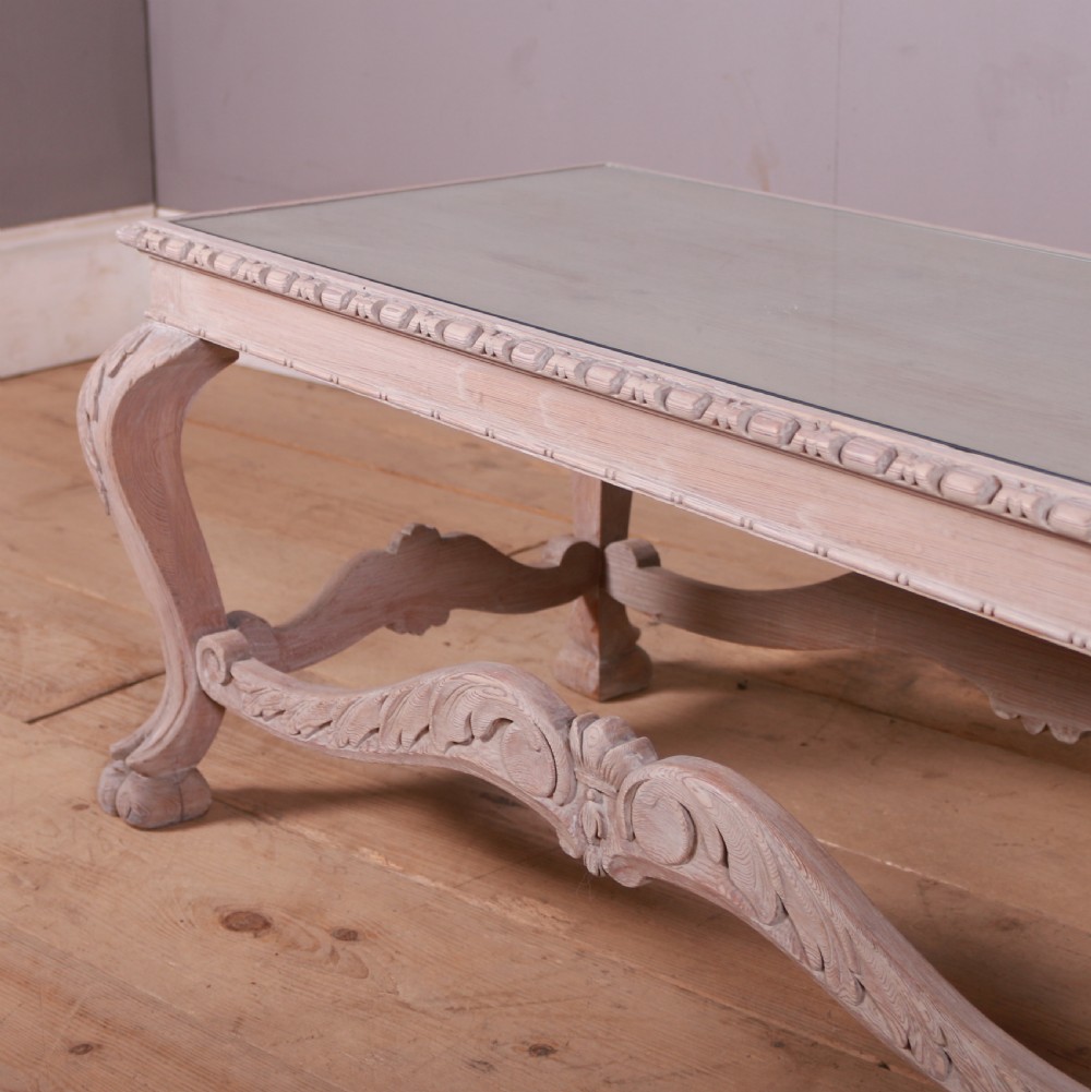 A low rectangular Dutch bleached pine coffee table featuring acanthus leaf carvings, ornate scrolled stretchers, claw feet, and an inset glass top. View III