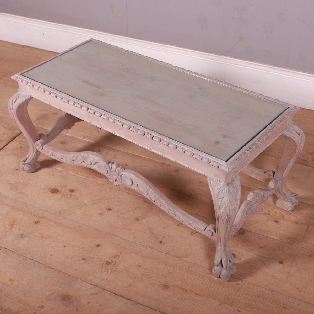 A low rectangular Dutch bleached pine coffee table featuring acanthus leaf carvings, ornate scrolled stretchers, claw feet, and an inset glass top. View IV