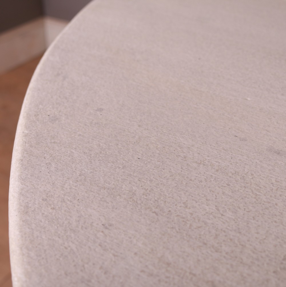 A circular off-white painted wooden dining table featuring five turned legs fitted with brass castors. View VII