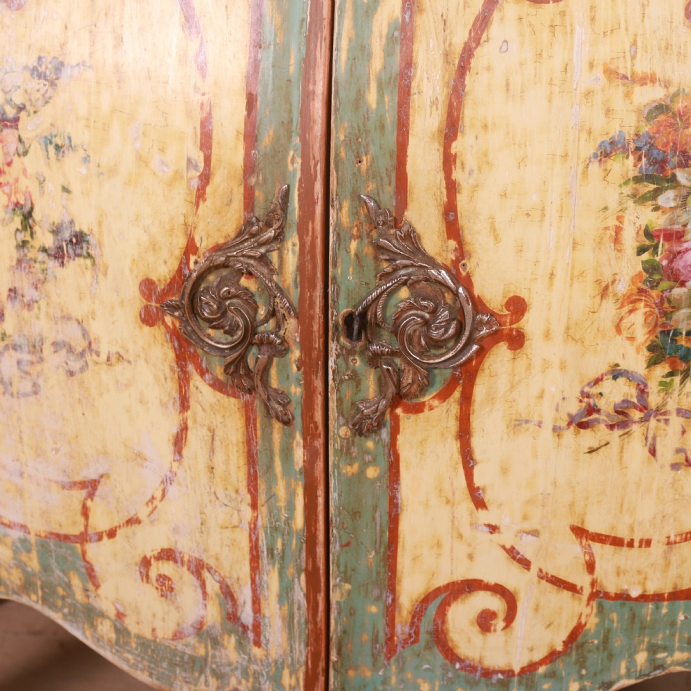 A Venetian serpentine painted wooden buffet cabinet featuring hand-painted floral cartouches, a polychrome green and cream finish, and metal corner mounts. View IV
