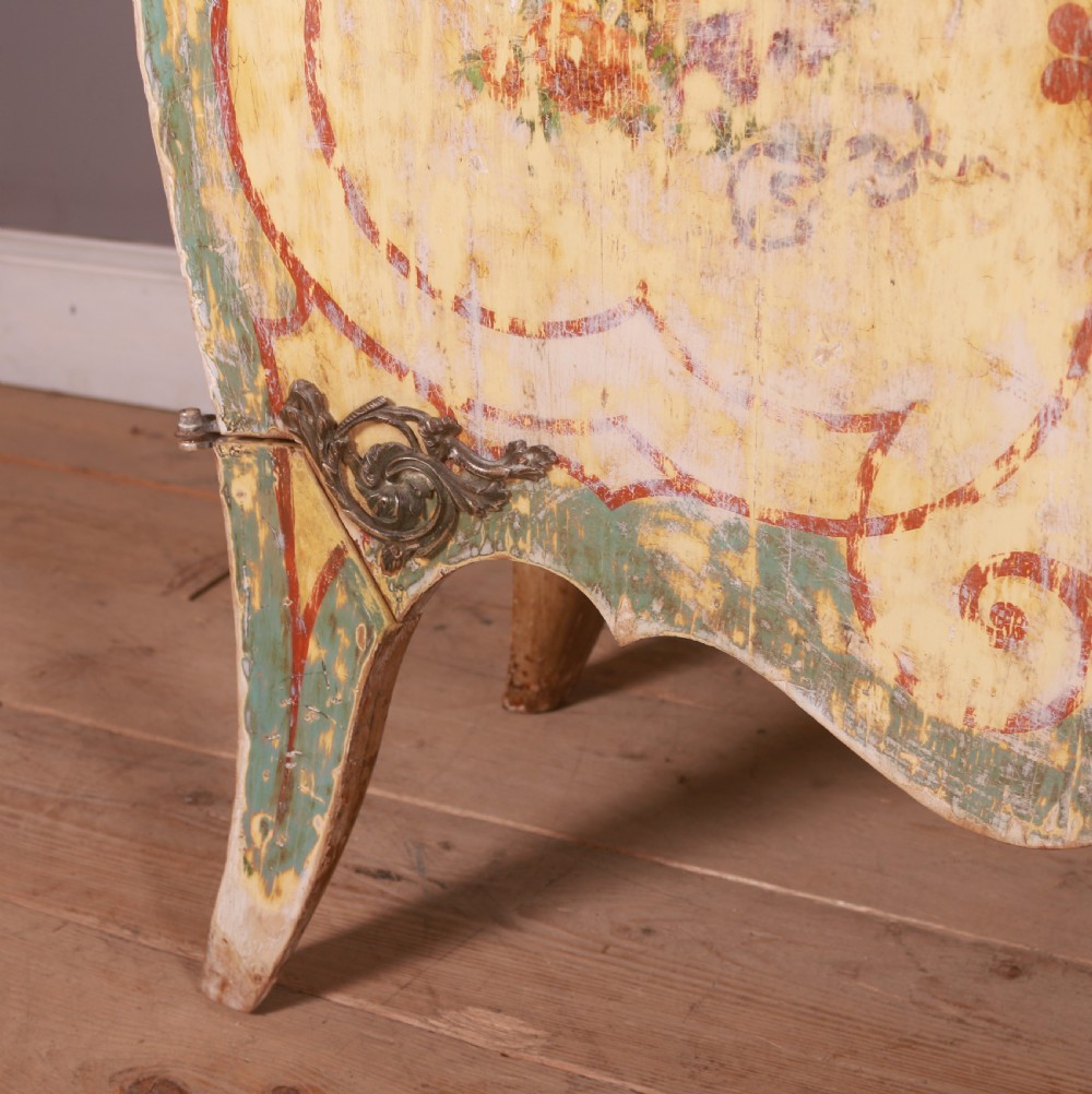 A Venetian serpentine painted wooden buffet cabinet featuring hand-painted floral cartouches, a polychrome green and cream finish, and metal corner mounts. View V