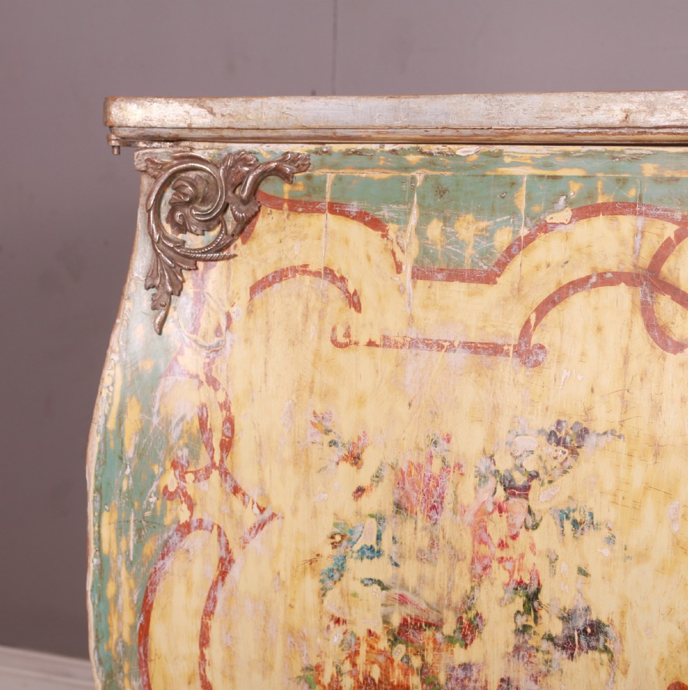A Venetian serpentine painted wooden buffet cabinet featuring hand-painted floral cartouches, a polychrome green and cream finish, and metal corner mounts. View VI
