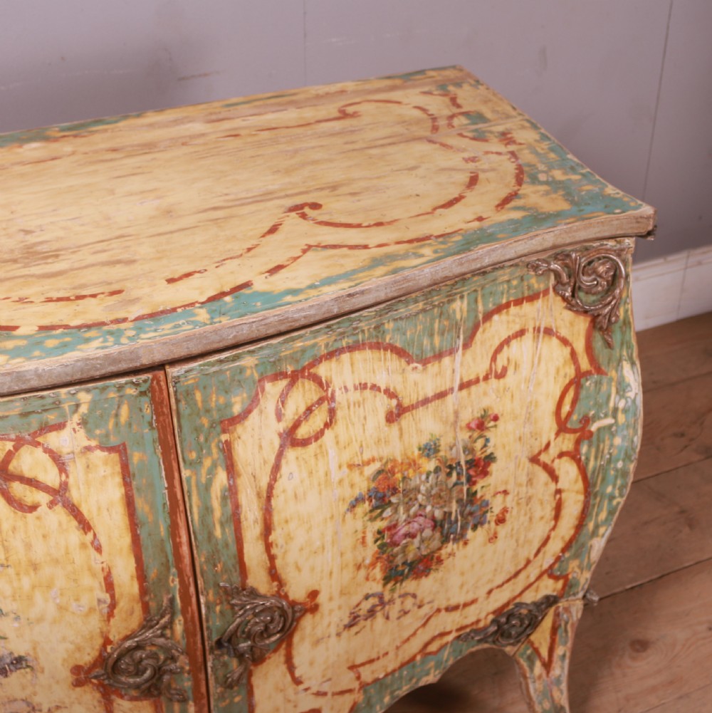 A Venetian serpentine painted wooden buffet cabinet featuring hand-painted floral cartouches, a polychrome green and cream finish, and metal corner mounts. View VIII