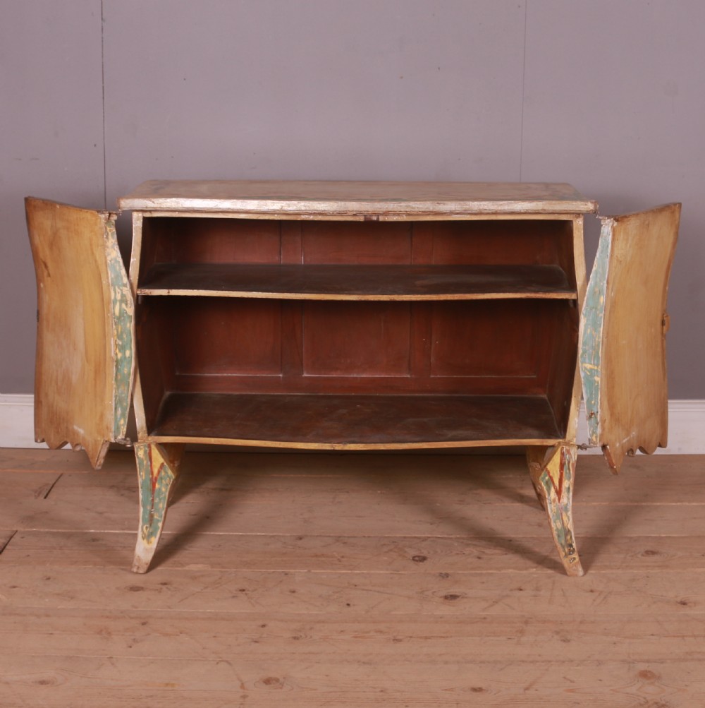 A Venetian serpentine painted wooden buffet cabinet featuring hand-painted floral cartouches, a polychrome green and cream finish, and metal corner mounts. View IX