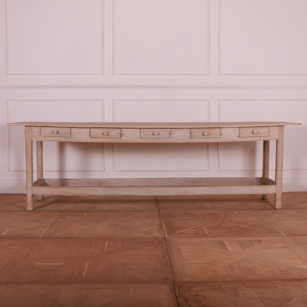 A long bleached oak serving table with five drawers, turned wooden knobs, square legs, and a low stretcher frame. View II