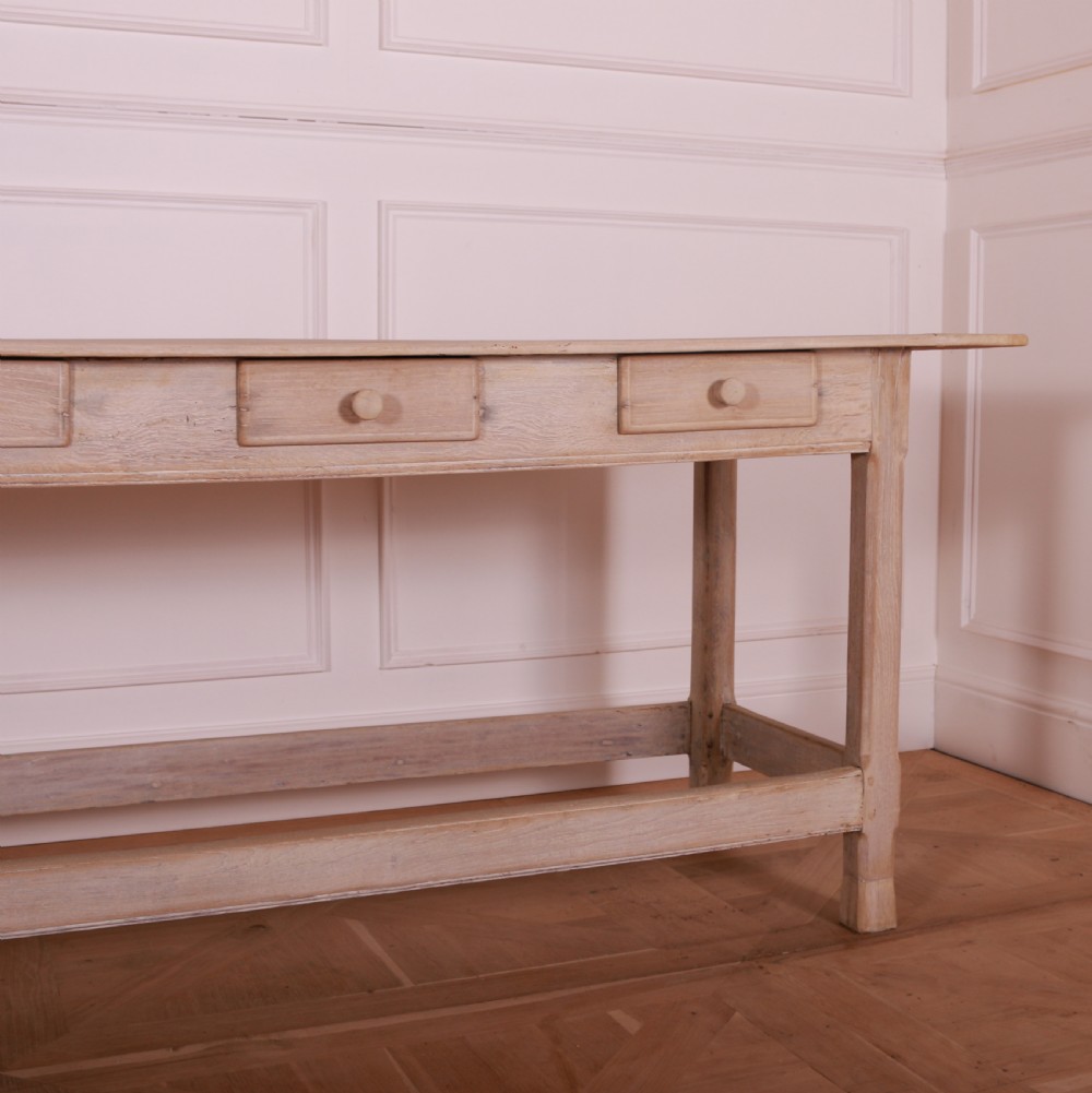 A long bleached oak serving table with five drawers, turned wooden knobs, square legs, and a low stretcher frame. View IV