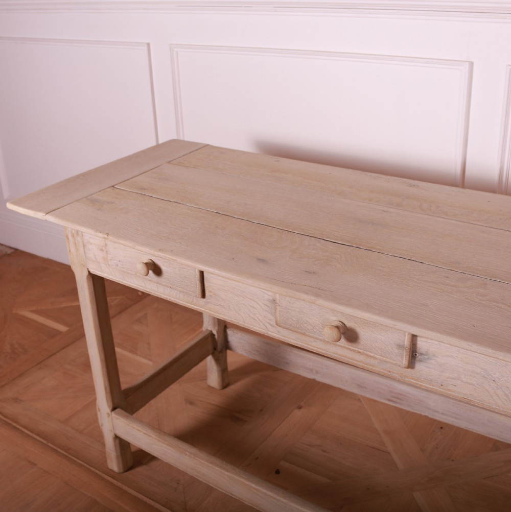A long bleached oak serving table with five drawers, turned wooden knobs, square legs, and a low stretcher frame. View V
