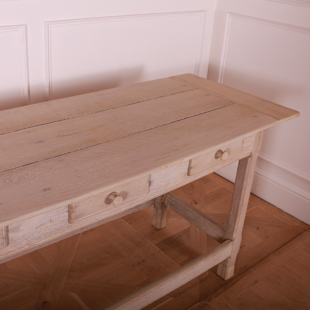 A long bleached oak serving table with five drawers, turned wooden knobs, square legs, and a low stretcher frame. View VI