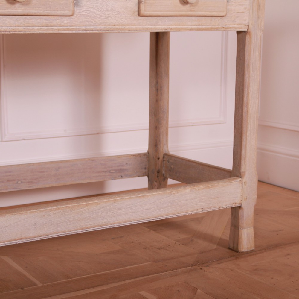 A long bleached oak serving table with five drawers, turned wooden knobs, square legs, and a low stretcher frame. View VIII