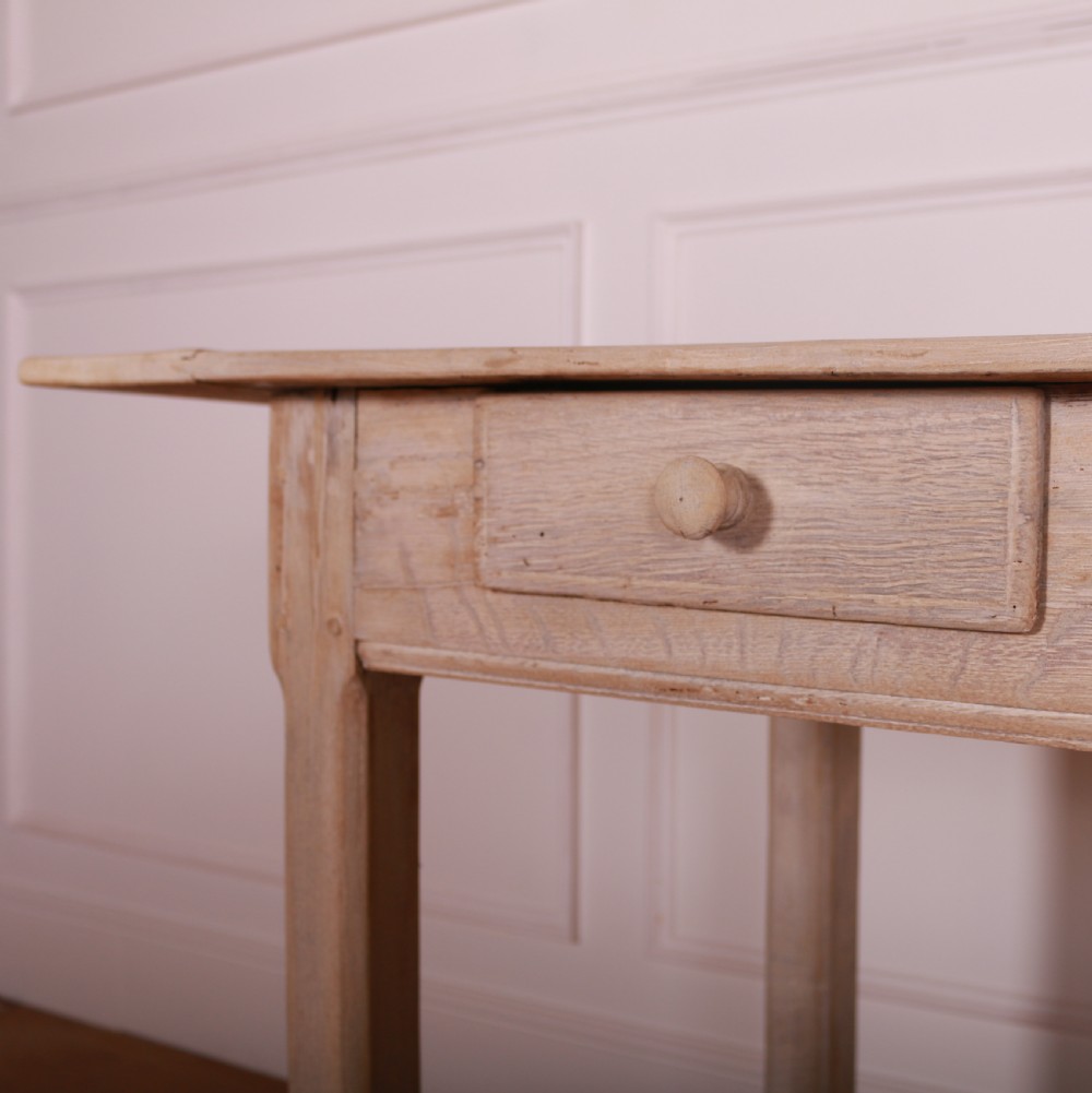 A long bleached oak serving table with five drawers, turned wooden knobs, square legs, and a low stretcher frame. View IX
