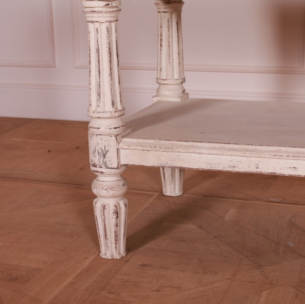 A cream painted pine side table featuring two drawers, turned fluted legs, a lower open shelf, and a dark contrasting top. View IV