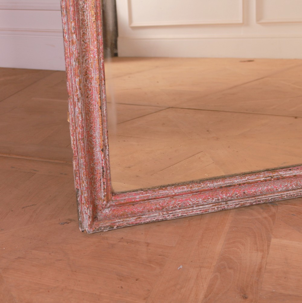 A large rectangular floor-leaning mirror featuring a distressed reddish-brown painted wooden frame and a clear reflective plate. View II