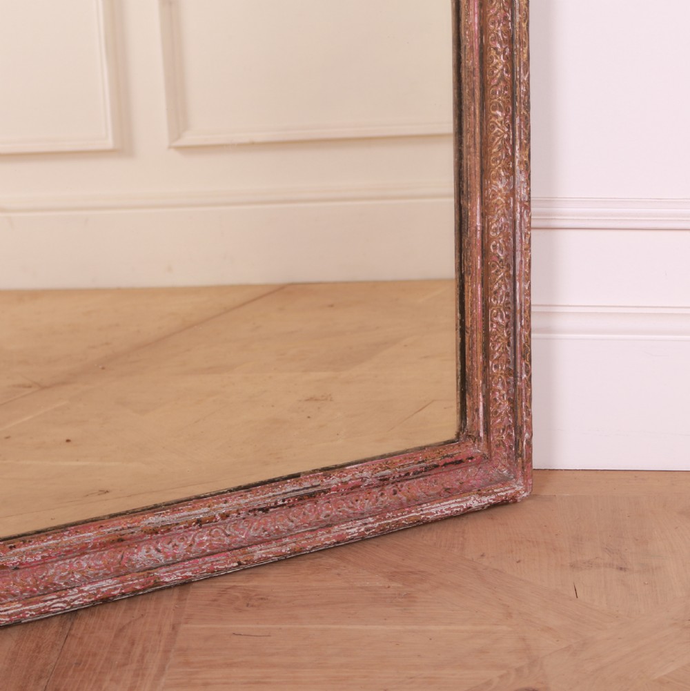 A large rectangular floor-leaning mirror featuring a distressed reddish-brown painted wooden frame and a clear reflective plate. View III