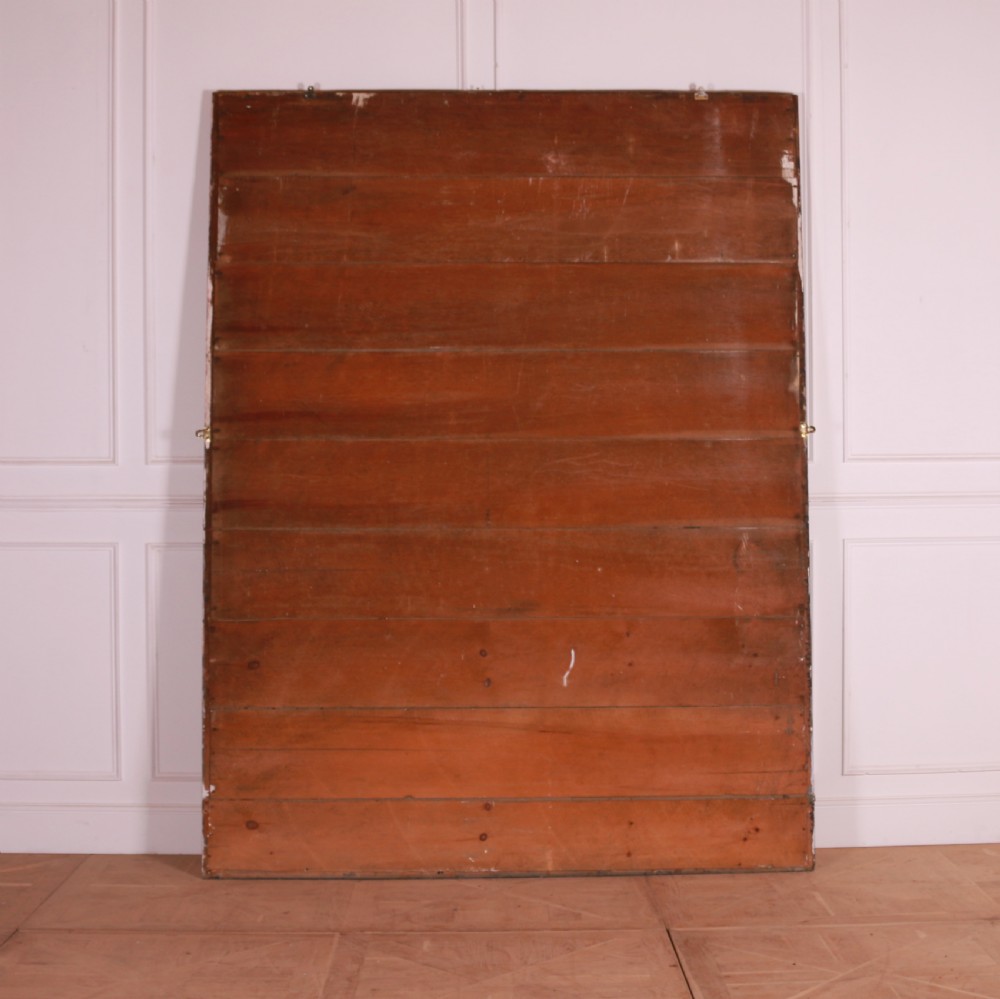 A large rectangular floor-leaning mirror featuring a distressed reddish-brown painted wooden frame and a clear reflective plate. View VI