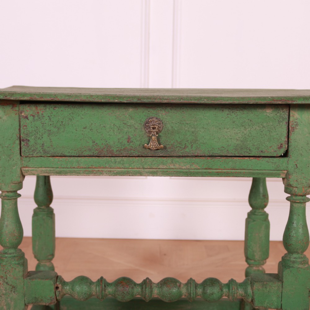 An 18th-century English painted green side table featuring a rectangular top, single drawer with brass escutcheon, turned legs, and a bobbin stretcher. View II