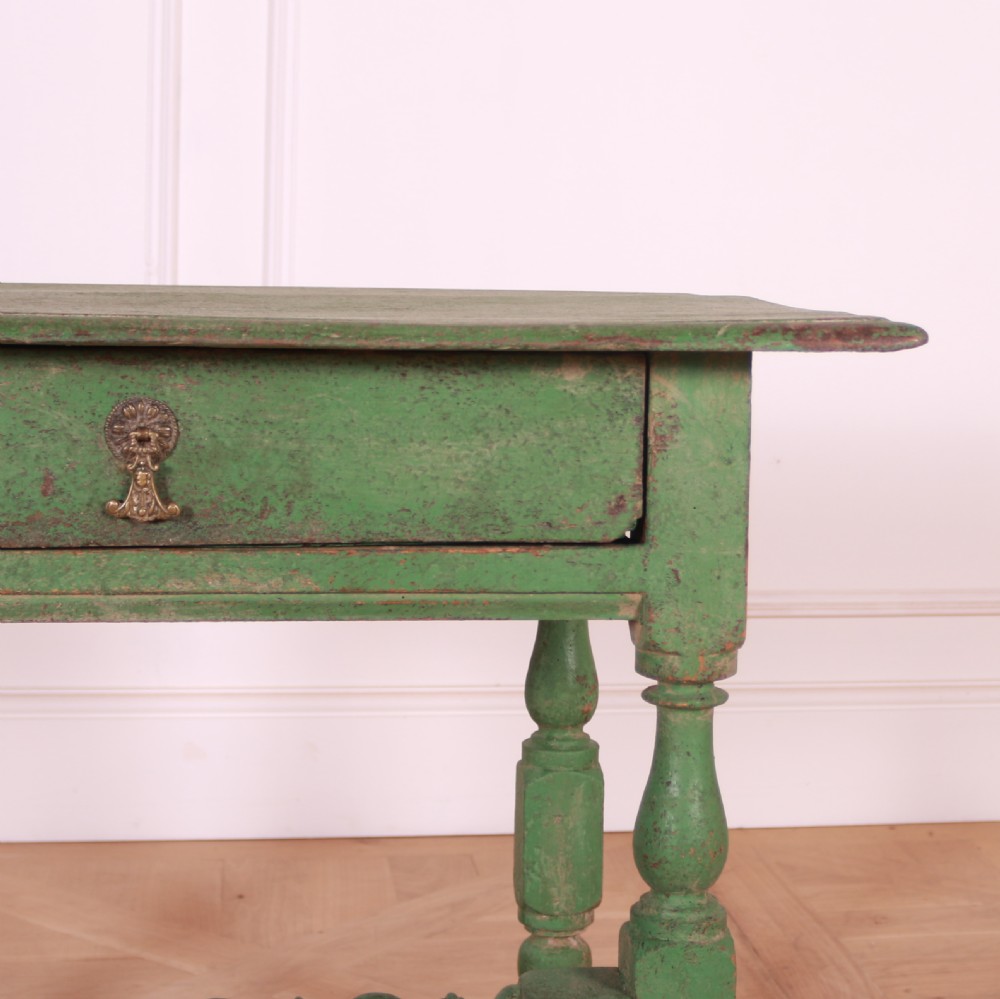 An 18th-century English painted green side table featuring a rectangular top, single drawer with brass escutcheon, turned legs, and a bobbin stretcher. View VI