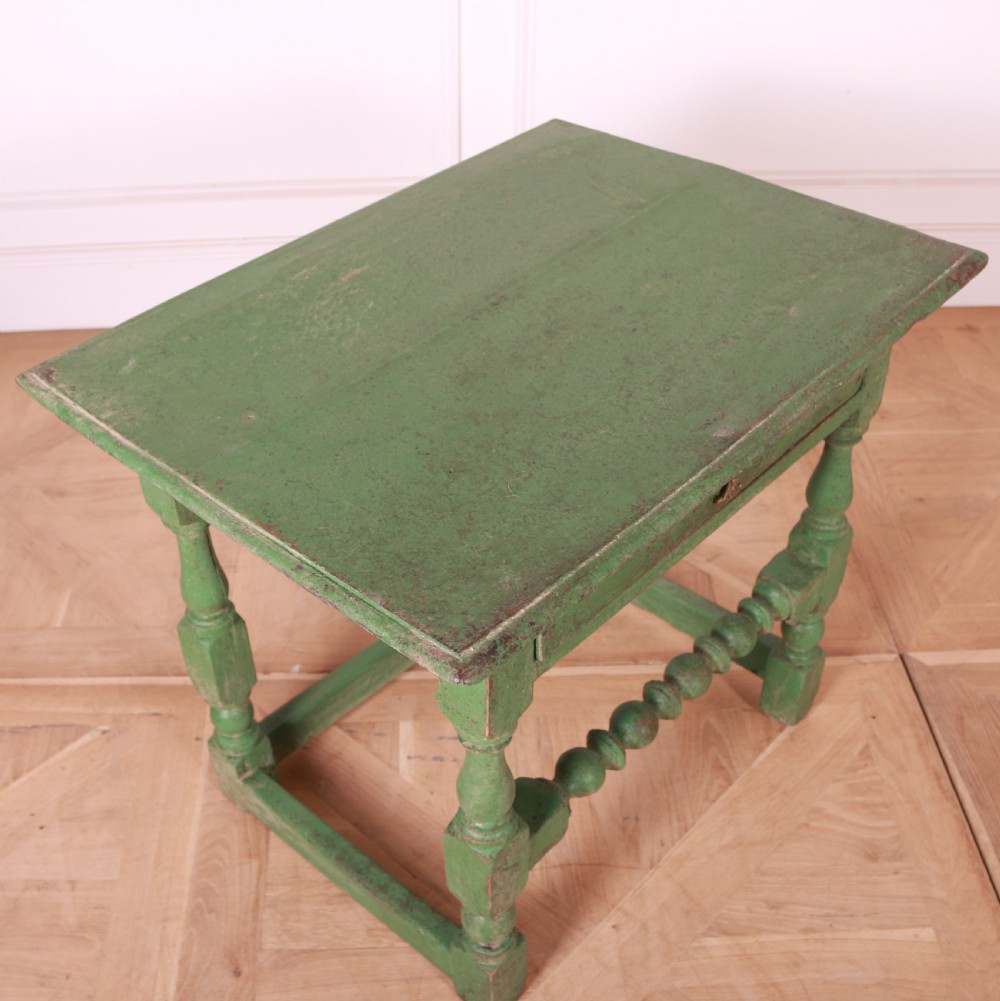 An 18th-century English painted green side table featuring a rectangular top, single drawer with brass escutcheon, turned legs, and a bobbin stretcher. View VIII