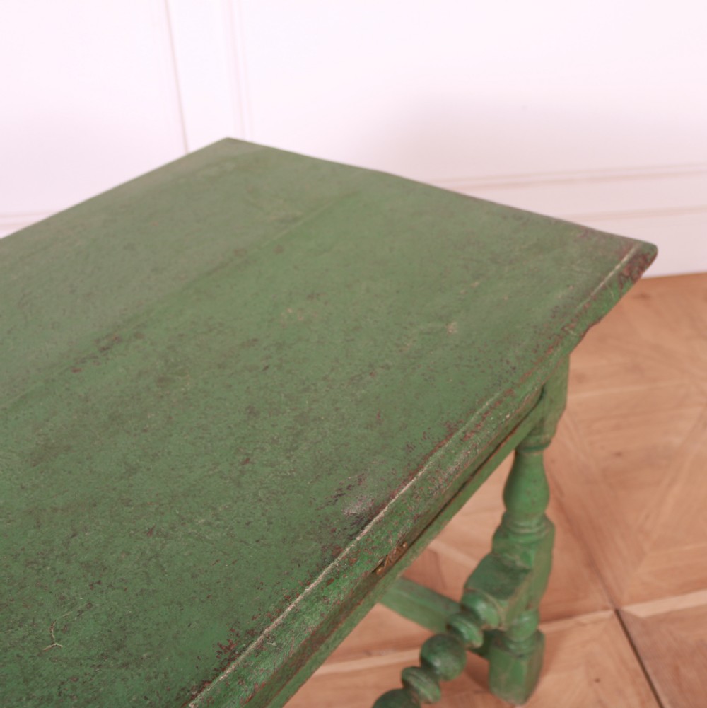 An 18th-century English painted green side table featuring a rectangular top, single drawer with brass escutcheon, turned legs, and a bobbin stretcher. View IX